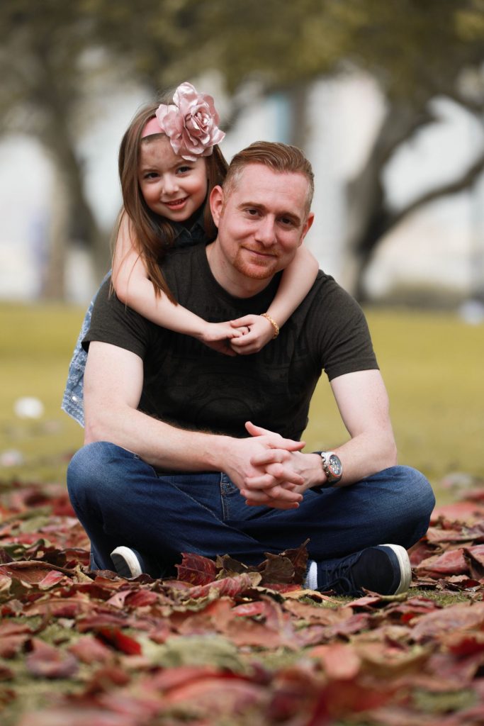Father and daughter giggling during a family photography session in Dubai